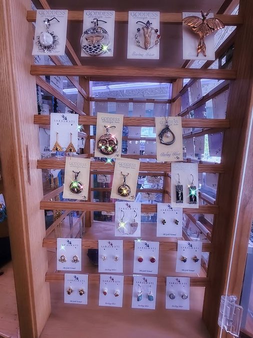 A jewelry display case with pendants and earrings