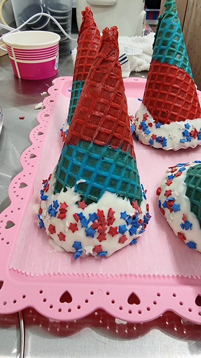 Hand-decorated waffle cone shells with red, white and blue sprinkles at Sweet Spot Saugatuck