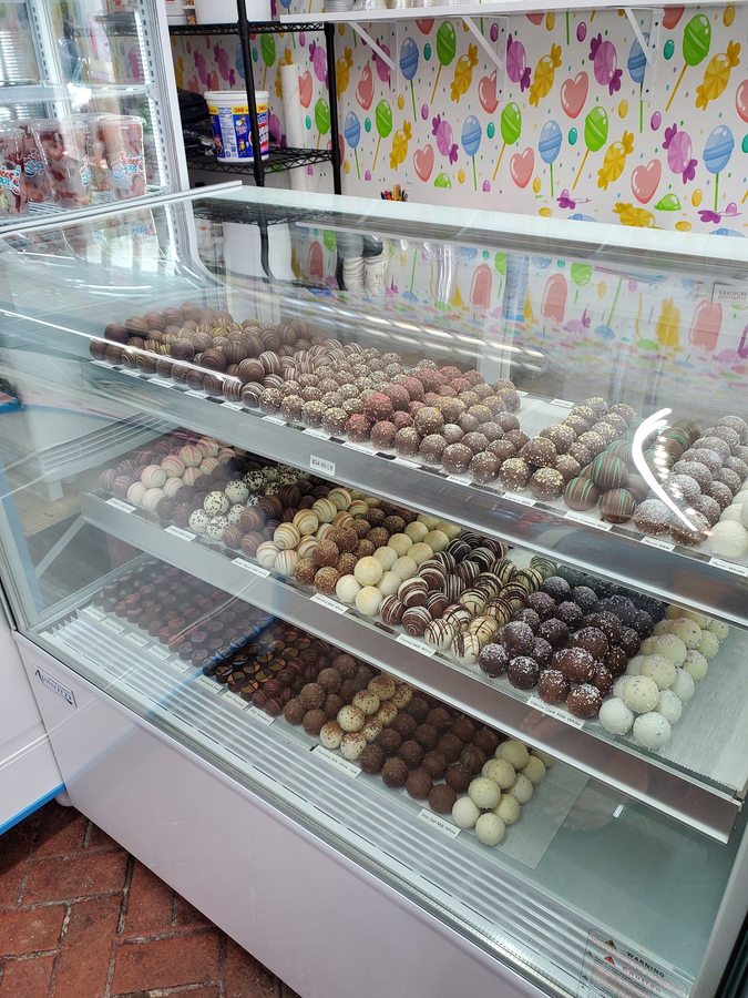 Chocolate praline and truffle display case at Sweet Spot Saugatuck