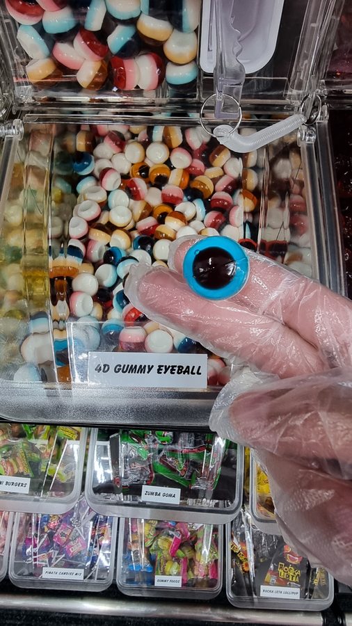 4D gummy eyeball bulk candy bin with a labeled bin card at Sweet Spot Saugatuck