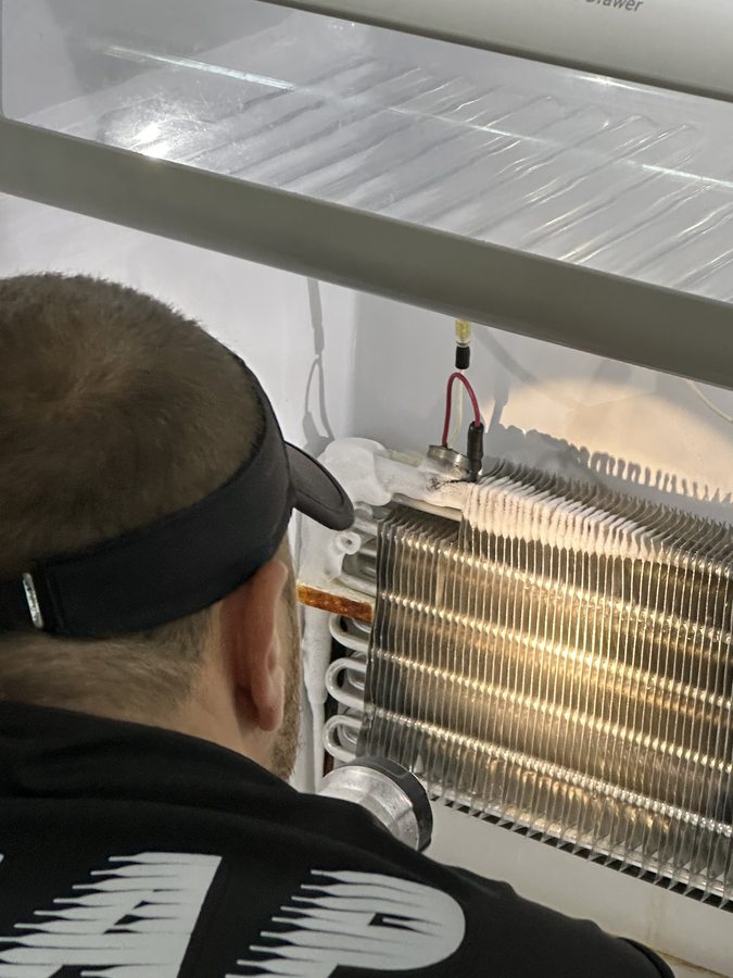 ASAP technician diagnosing and repairing an appliance on site