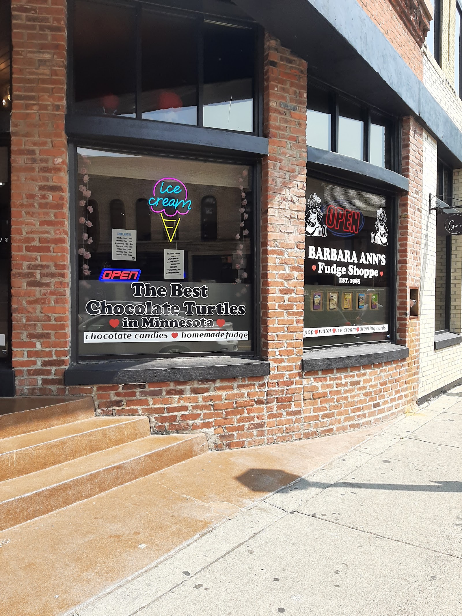 Barbara Ann's Fudge Shoppe storefront on Main Street, Stillwater — EST. 1995 window signage on a brick corner building