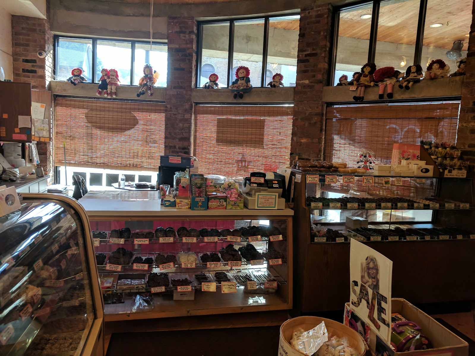 Inside Barbara Ann's — candy cases along the wall, exposed brick, and the shop's historic windows