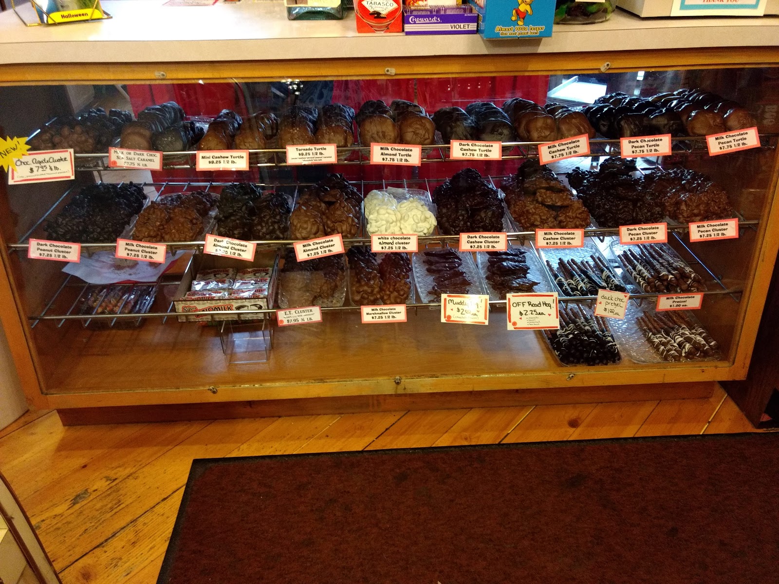 Glass case of Barbara Ann's handmade turtles and clusters, with red price labels